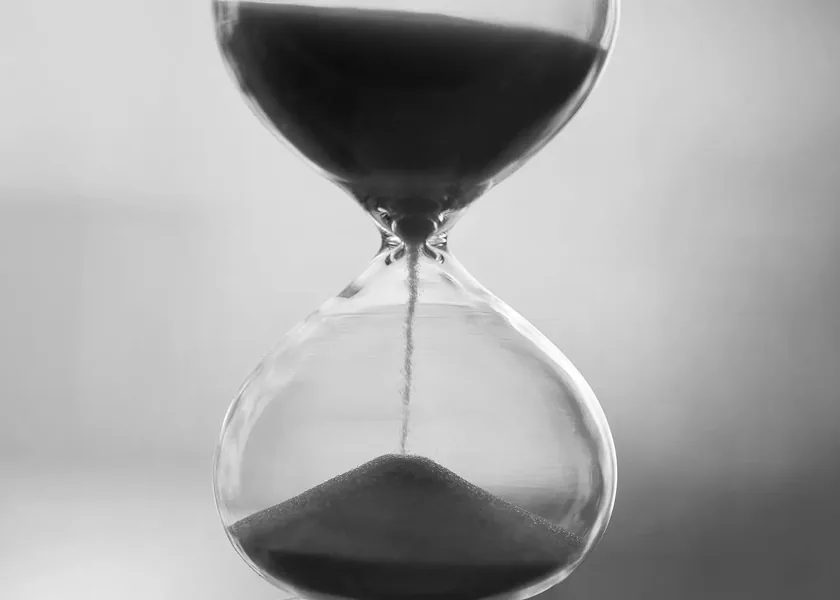 Hourglass with sand running through it