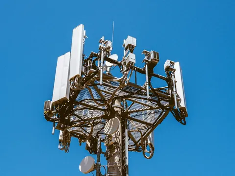 Telecommunications tower carrying panel antennas