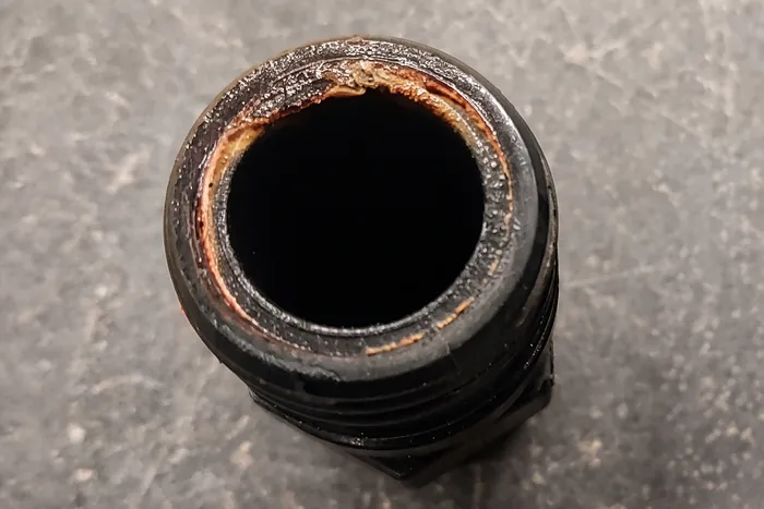 Inside of an untreated water line, fouled with biofilm and scale